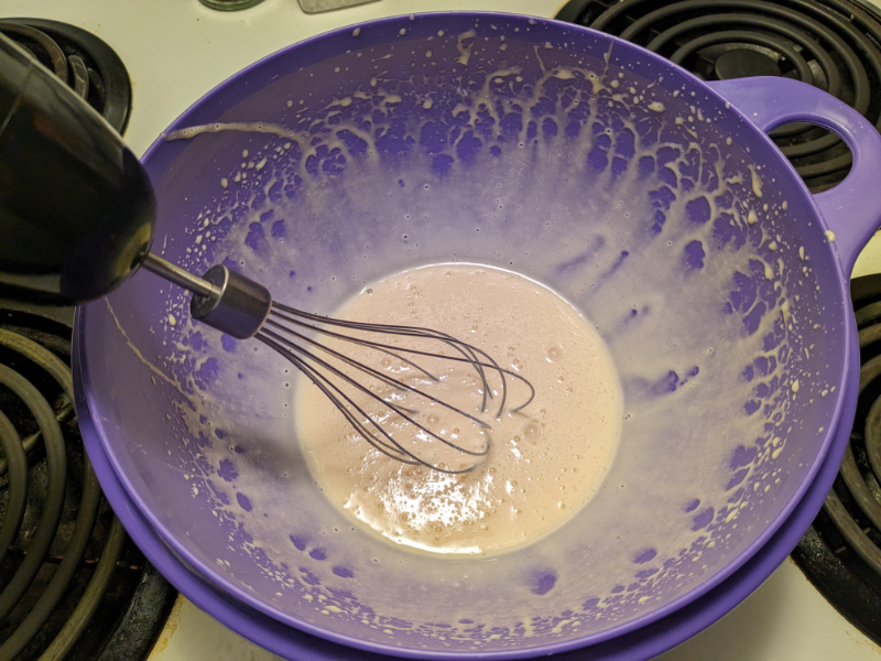 Image of the egg and condensed milk custard being whipped in a bowl.