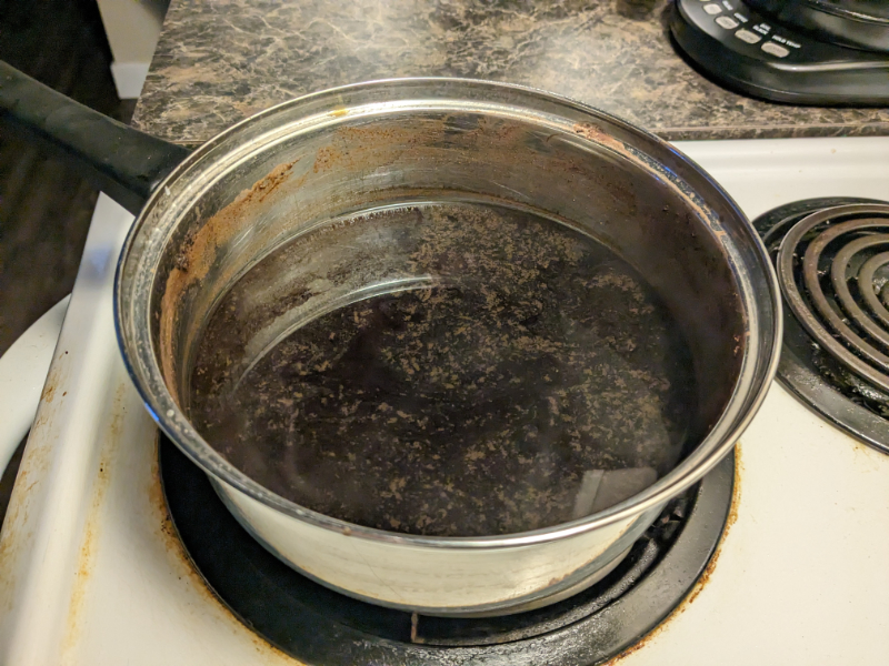 Image of the finished pot of boiled coffee, but where the grounds have not been clarified out of the liquid.